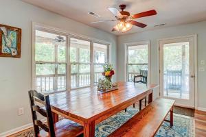 a dining room with a wooden table and a ceiling fan at In Spite of Ourselves in Edisto Beach
