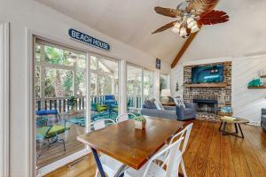 a living room with a table and a fireplace at Artsea Phartsea in Edisto Beach