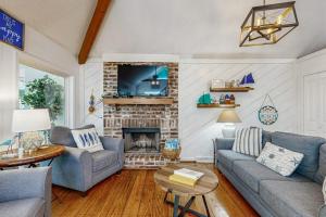 a living room with a couch and a fireplace at Artsea Phartsea in Edisto Beach