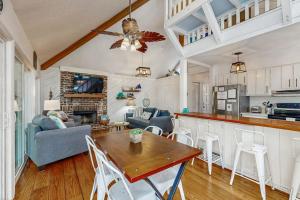 a kitchen and living room with a table and chairs at Artsea Phartsea in Edisto Beach +21 photos