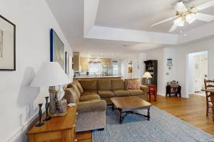 a living room with a couch and a table at Cupid's Nest in Edisto Beach