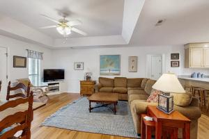 a living room with a couch and a table at Cupid's Nest in Edisto Beach
