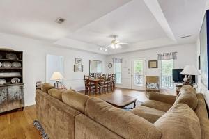 a living room with a large couch and a table at Cupid's Nest in Edisto Beach