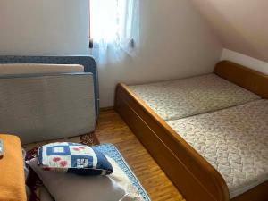 a small bedroom with two beds and a window at Lucky lak in Miercurea-Ciuc
