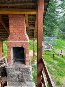 a brick oven sitting under a wooden roof at Lucky lak in Miercurea-Ciuc
