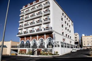a white building with balconies on the side of it at The Classic Palace in Abha