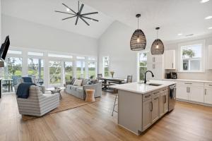 a kitchen and living room with a couch and a table at Champagne and Sunsets in Edisto Island