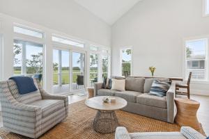 a living room with a couch and chairs and a table at Champagne and Sunsets in Edisto Island