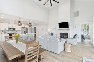 a living room and kitchen with a table and a couch at Champagne and Sunsets in Edisto Island