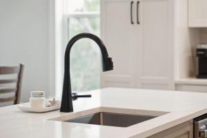 a kitchen sink with a faucet on a counter at Champagne and Sunsets in Edisto Island +42 photos