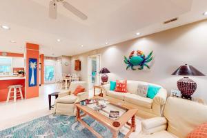 a living room with a couch and a table at Slow Drift in Edisto Beach