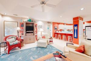 a living room filled with furniture and a kitchen at Slow Drift in Edisto Beach