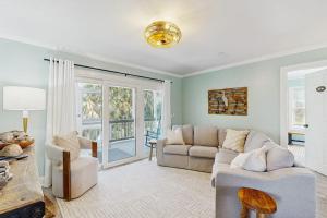 a living room with a couch and a chair at Heaven on Harrelson in Edisto Beach
