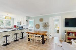 a kitchen and dining room with a table and chairs at Heaven on Harrelson in Edisto Beach