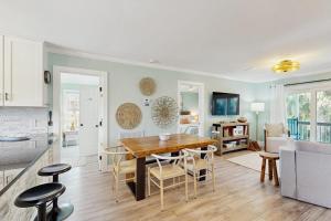 a kitchen and dining room with a table and chairs at Heaven on Harrelson in Edisto Beach