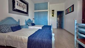 a bedroom with two beds with blue cabinets at Mistura Fina in Sal Rei +64 photos