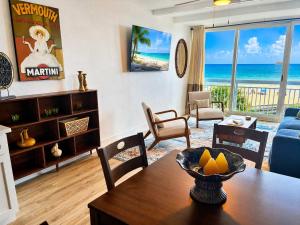 a living room with a table and a view of the ocean at Renovated Oceanfront 1BR by Skywheel Yachtsman 400 in Myrtle Beach