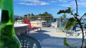 a patio with chairs and a table on a balcony at Blue Flamingo Kite Beach in Cabarete