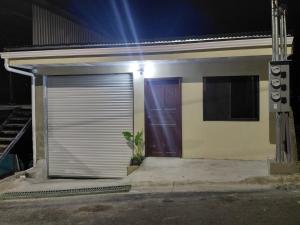 a garage door of a house at night at Apartamentos Torres Manuel Antonio in Manuel Antonio
