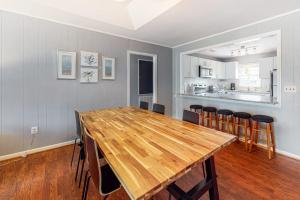 a dining room with a wooden table and chairs at Hamptons South in Edisto Beach
