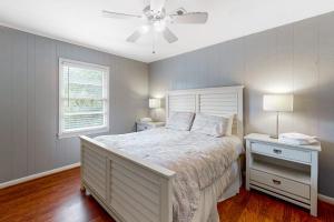 a bedroom with a bed and a ceiling fan at Hamptons South in Edisto Beach