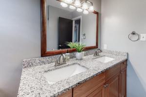 a bathroom with two sinks and a mirror at Hamptons South in Edisto Beach +20 photos