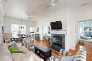 a living room with a couch and a fireplace at Myra's Cottage in Edisto Beach