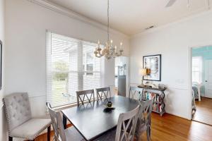 a dining room with a table and chairs at Myra's Cottage in Edisto Beach +17 photos