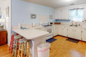 a kitchen with white cabinets and a stove top oven at Sand Quarters in Edisto Beach