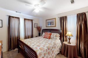 a bedroom with a bed and a table with a lamp at Sand Quarters in Edisto Beach +13 photos