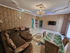 a living room with a couch and a table at Riverside Villa GDR in Gabala