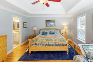 a bedroom with a bed and a blue rug at Chateau Relaxo in Edisto Beach