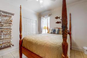 a bedroom with a large bed with a wooden frame at Stare-Gazing in Edisto Beach