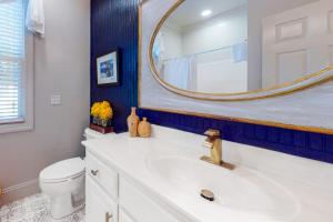 a bathroom with a white sink and a mirror at Stare-Gazing in Edisto Beach