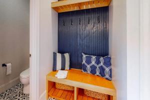 a bathroom with a bench with pillows and a toilet at Stare-Gazing in Edisto Beach