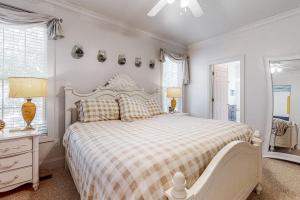 a bedroom with a large bed with a checkered blanket at Stare-Gazing in Edisto Beach +31 photos