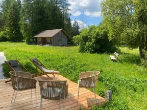 a group of chairs sitting on a wooden deck at Refugium Mitterbach in Mitterbach