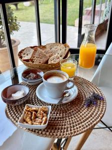 a breakfast table with a cup of coffee and bread at Huellas del Trapiche Apart in Chilecito