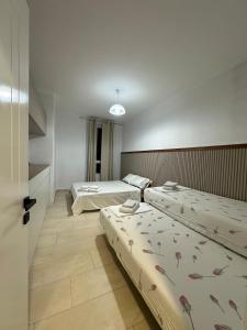 a room with two beds and a door with two beds at River apartment in Tushemisht