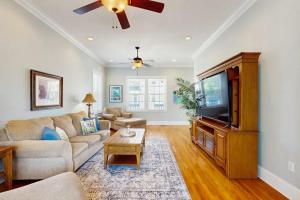 a living room with a couch and a flat screen tv at King Cotton Villa 17 in Edisto Beach