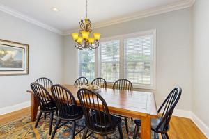a dining room with a wooden table and chairs at King Cotton Villa 17 in Edisto Beach