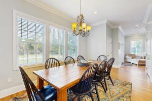a dining room with a wooden table and chairs at King Cotton Villa 17 in Edisto Beach