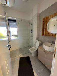 a bathroom with a toilet and a sink at River apartment in Tushemisht +14 photos