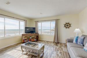 a living room with a couch and a tv at Corrigan in Edisto Beach