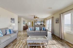 a living room with two couches and a table at Corrigan in Edisto Beach