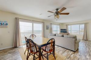 a living room with a table and chairs and a couch at Corrigan in Edisto Beach
