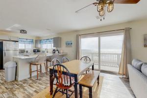 a kitchen and living room with a table and chairs at Corrigan in Edisto Beach