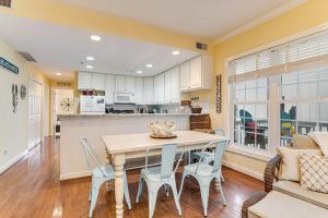 a kitchen and dining room with a table and chairs at The Retreat 7A in Edisto Beach