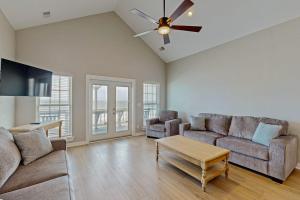 a living room with a couch and a ceiling fan at A Shore Thing in Edisto Beach