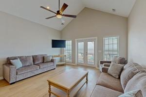 a living room with two couches and a ceiling fan at A Shore Thing in Edisto Beach
